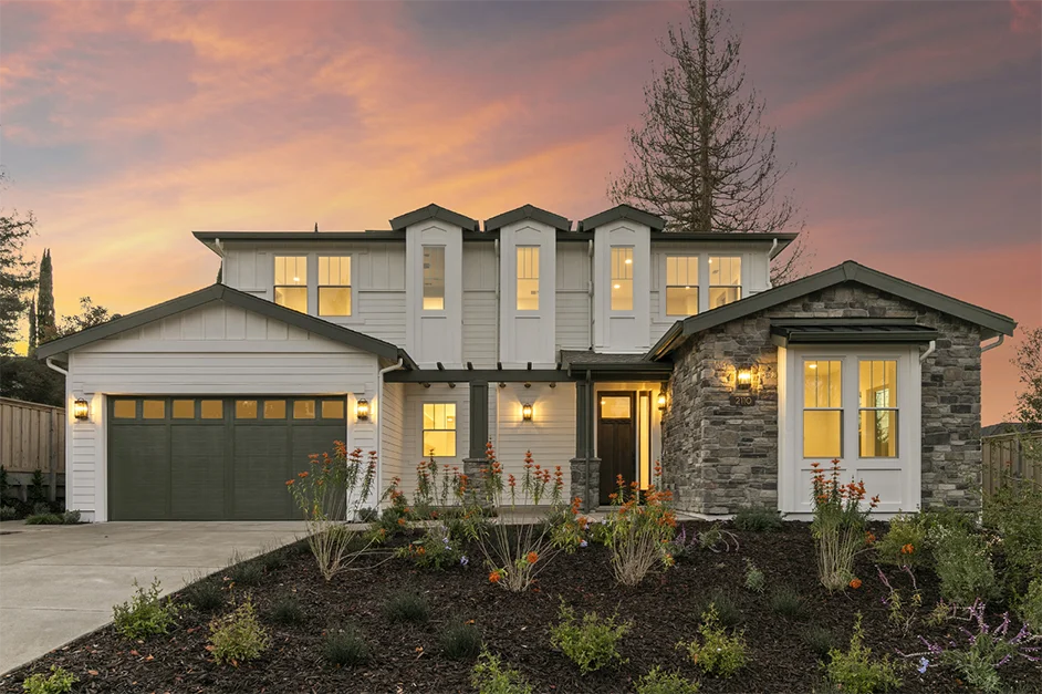 Newly-built TJH 2-story white home with stone facade.