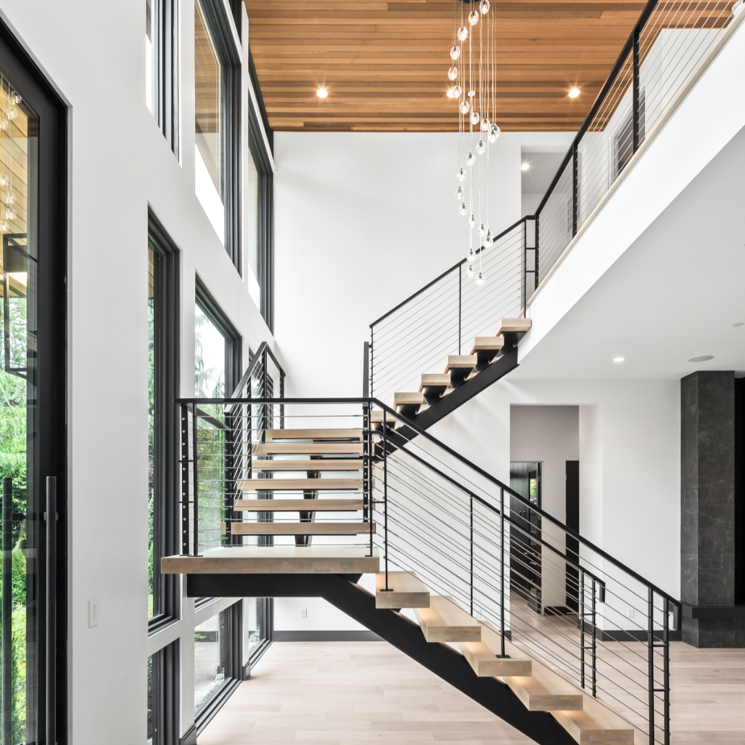 Luxury modern entry with iron floating staircase and chandelier.