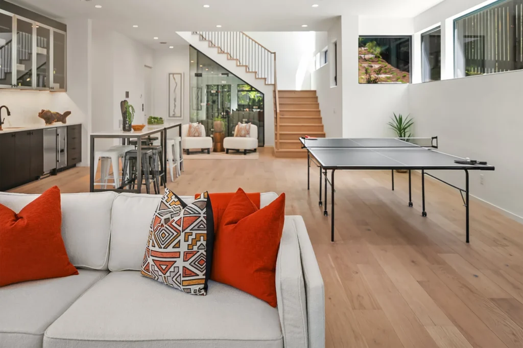 Bellevue Modern Style Home lower level rec room with table tennis, couch, mini-bar