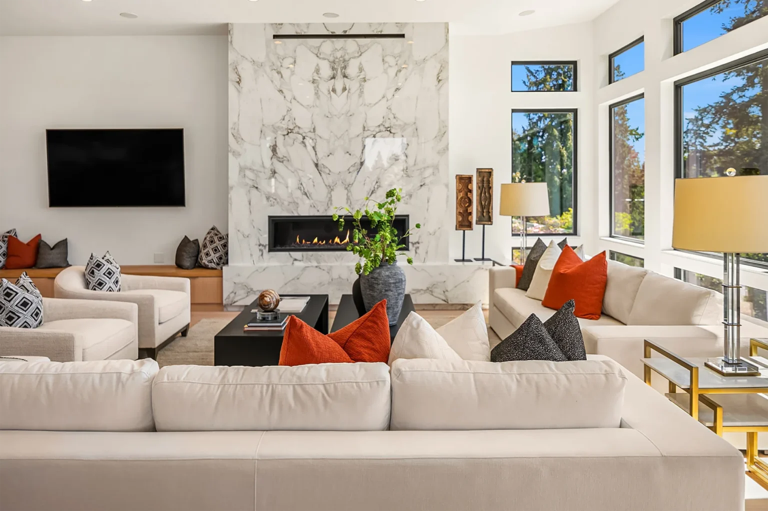 Bellevue Modern Style living room with couches and marble fireplace next to television