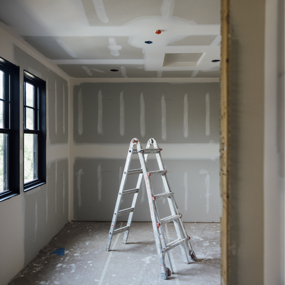 Image of interior bedroom under construction with ladder in the middle of the room.