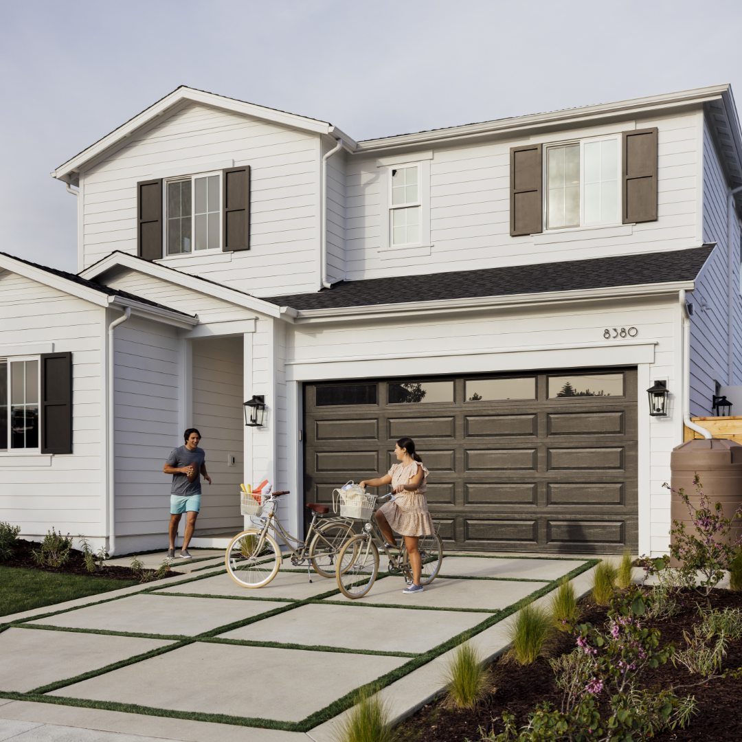 Traditional home exterior with brother and sister getting ready to go on a bike ride.