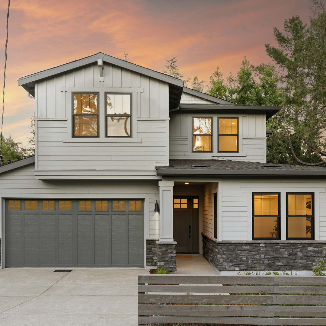 Exterior of gray traditional style TJH home at dusk