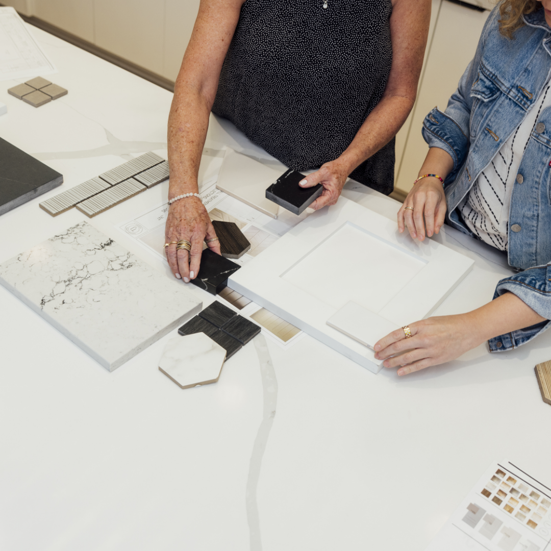 Image of two women curating design selects for interior design at TJH's design studio