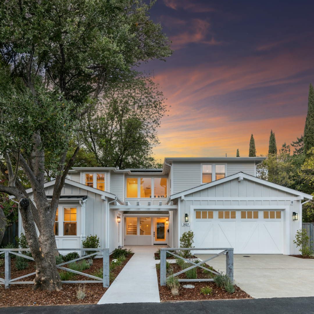 Exterior of craftsman-style TJH home with light gray and white paint at dusk