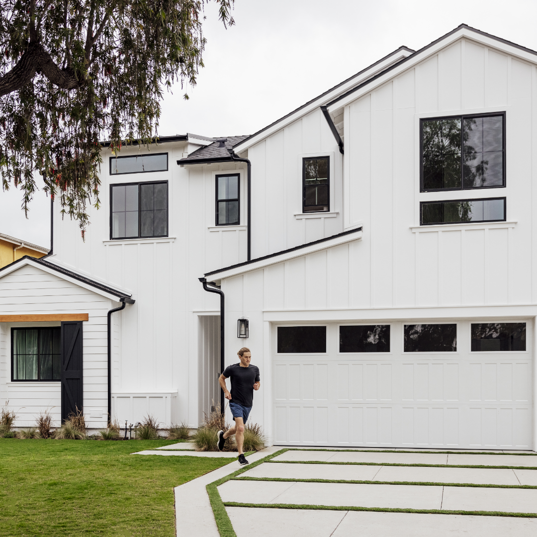 Image of modern farmhouse exterior with man heading out for a jog