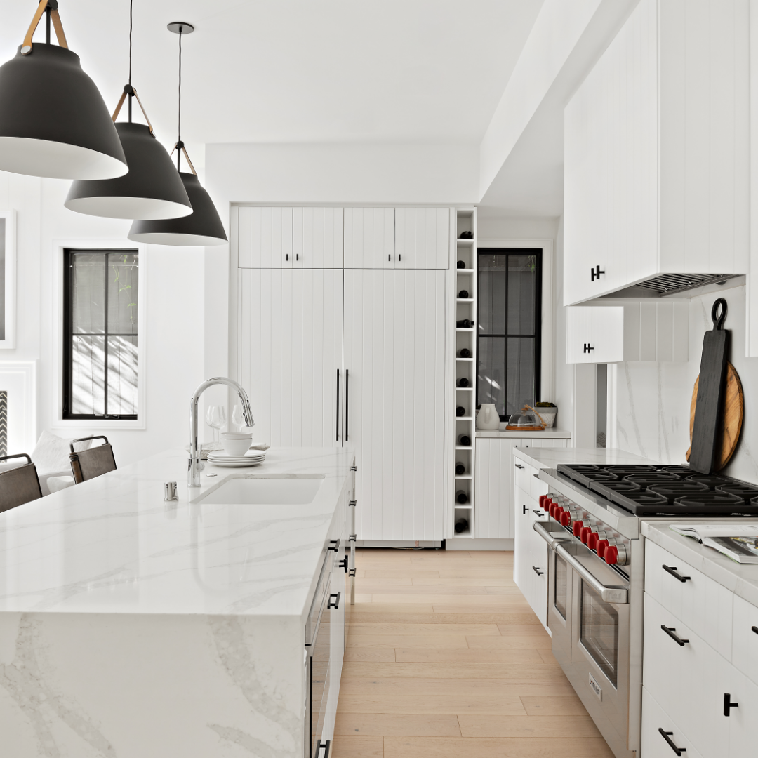 Image of luxury all-white TJH kitchen with black pendant lighting