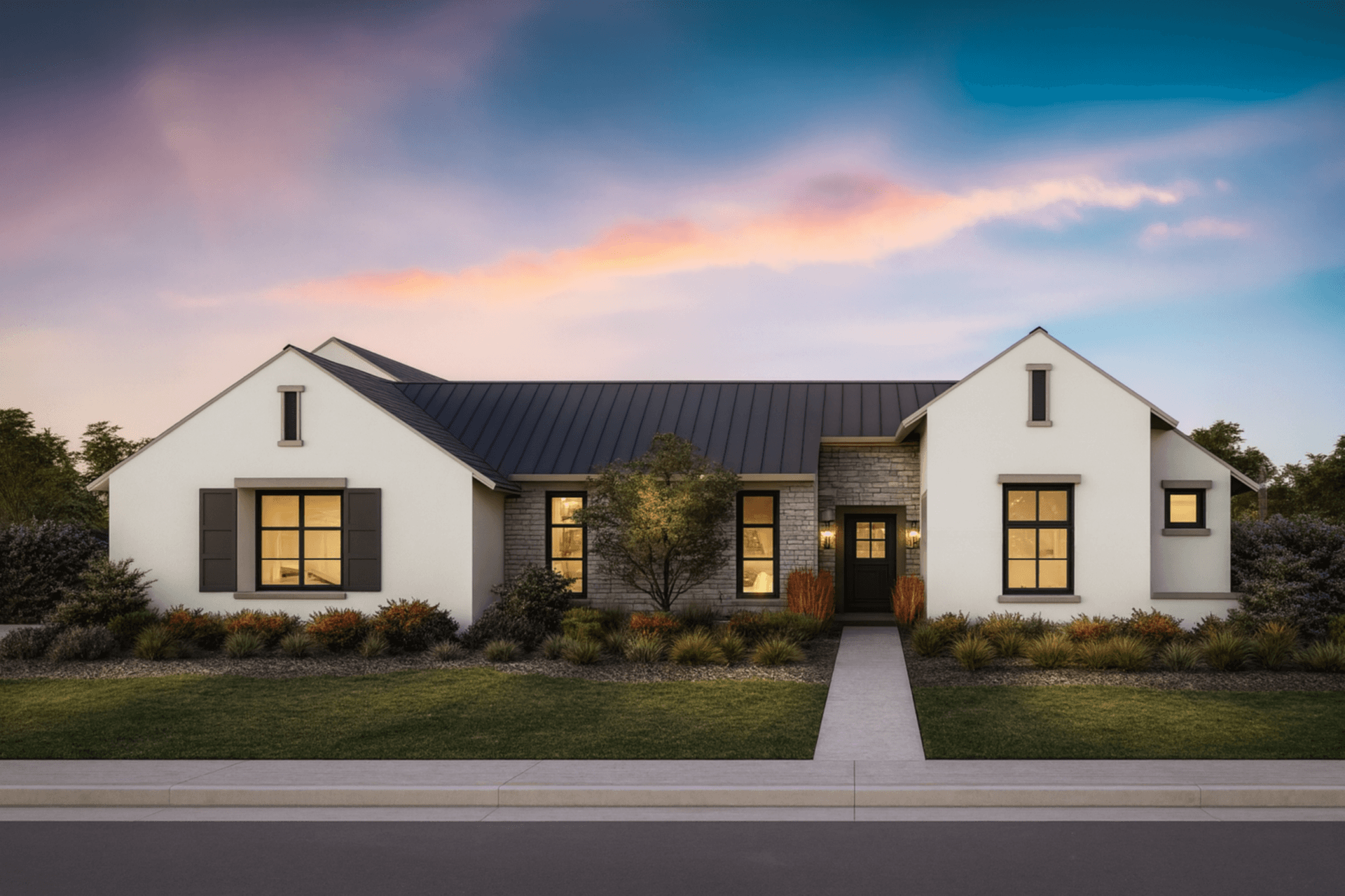 Modern single-story house with white exterior walls, dark roof, and large windows. A straight path leads to the front door, surrounded by neatly landscaped shrubs and trees, with a sunset sky in the background.