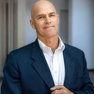Steve Schlageter, Chief Executive Officer of Thomas James Homes, wearing a blue blazer and white shirt, photographed against a neutral background