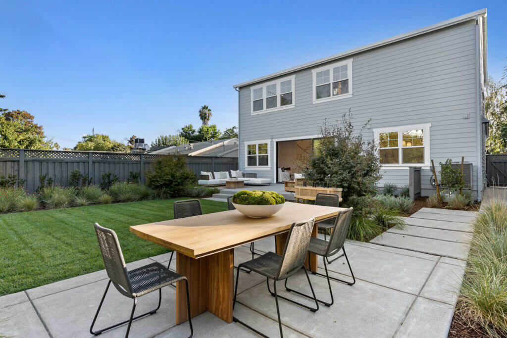 TJH home featuring a welcoming backyard, clean architectural lines, and thoughtfully designed landscaping.