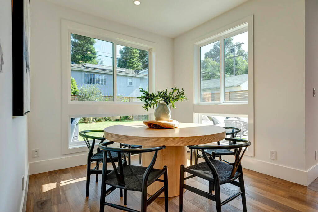 TJH Wisteria dining room in Southern California featuring large windows and a bright, modern aesthetic.