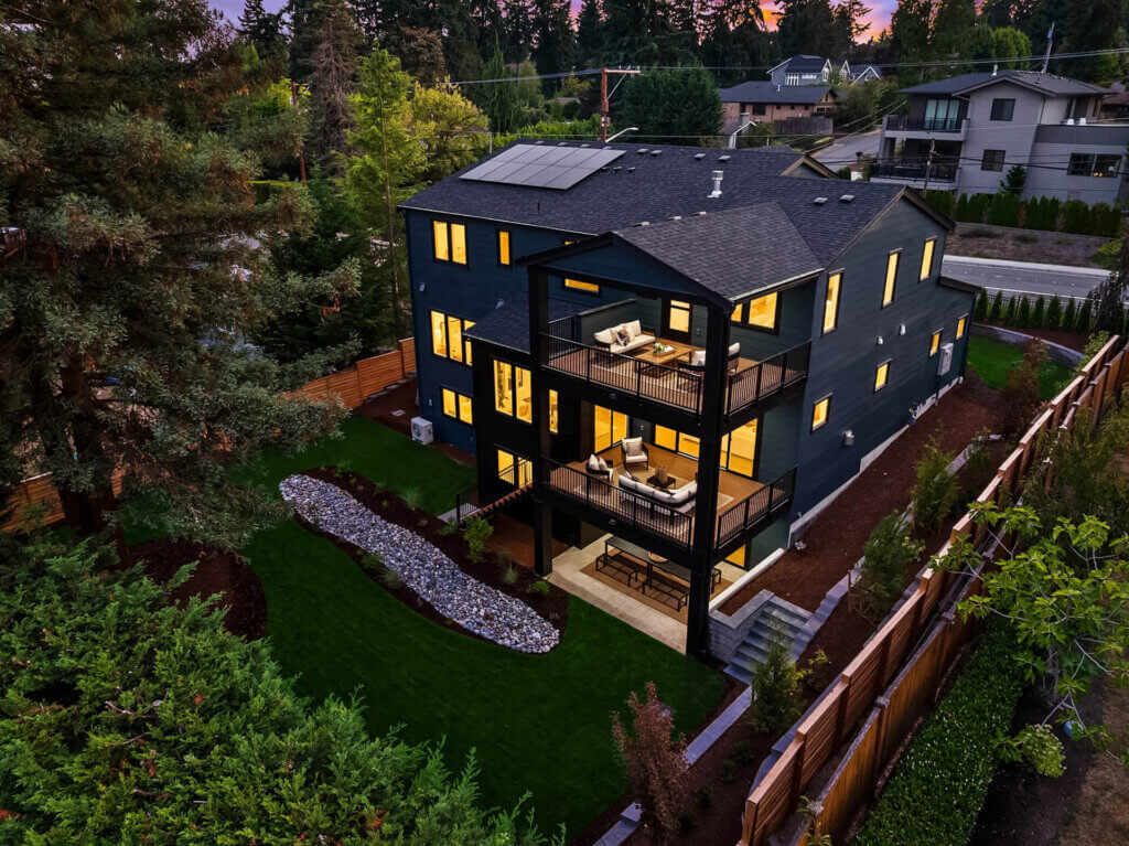 Aerial view of a TJH Webster home in the Pacific Northwest with surrounding neighborhood and lush tree canopy.