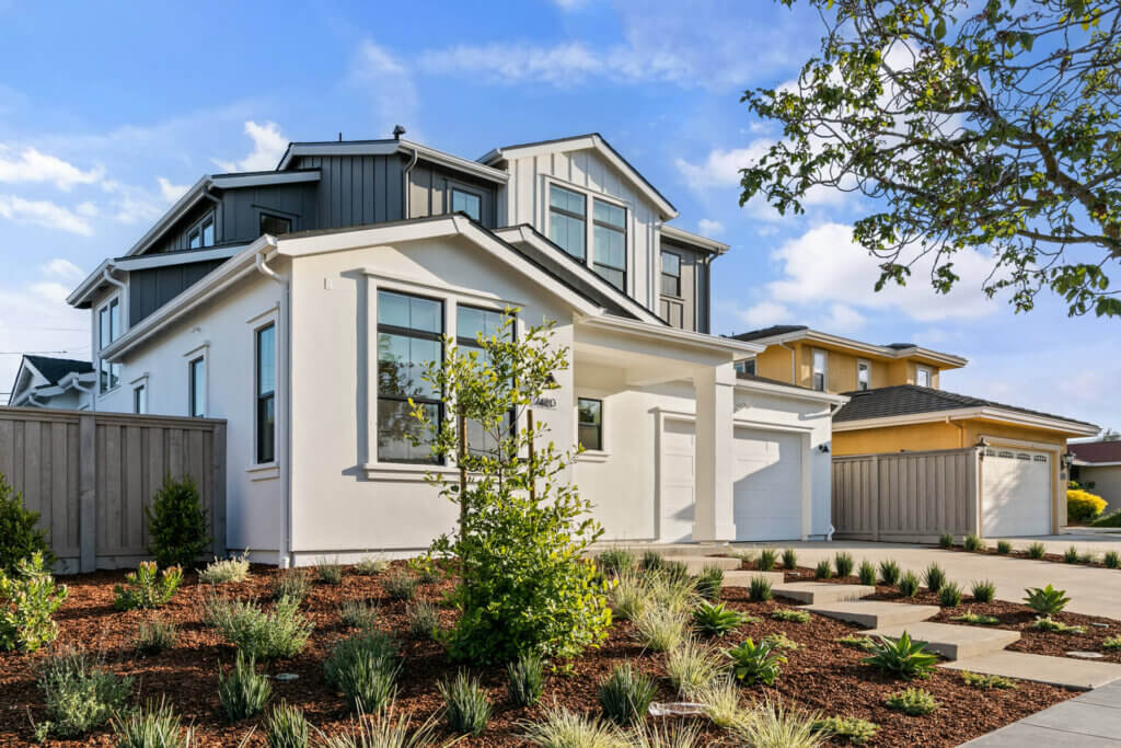 TJH Hackberry two-story home in Northern California with white and gray exterior, large windows, and a landscaped front yard