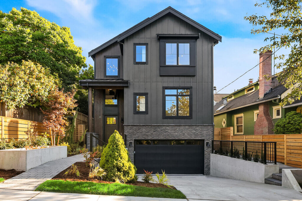 TJH Skyline exterior in the Pacific Northwest with modern siding, large windows, and manicured landscaping.