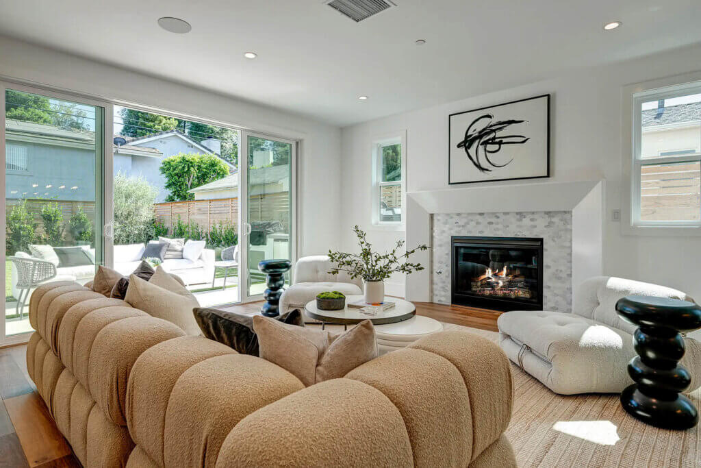 TJH Wisteria living room in Southern California featuring a gas fireplace and a bright, modern aesthetic.