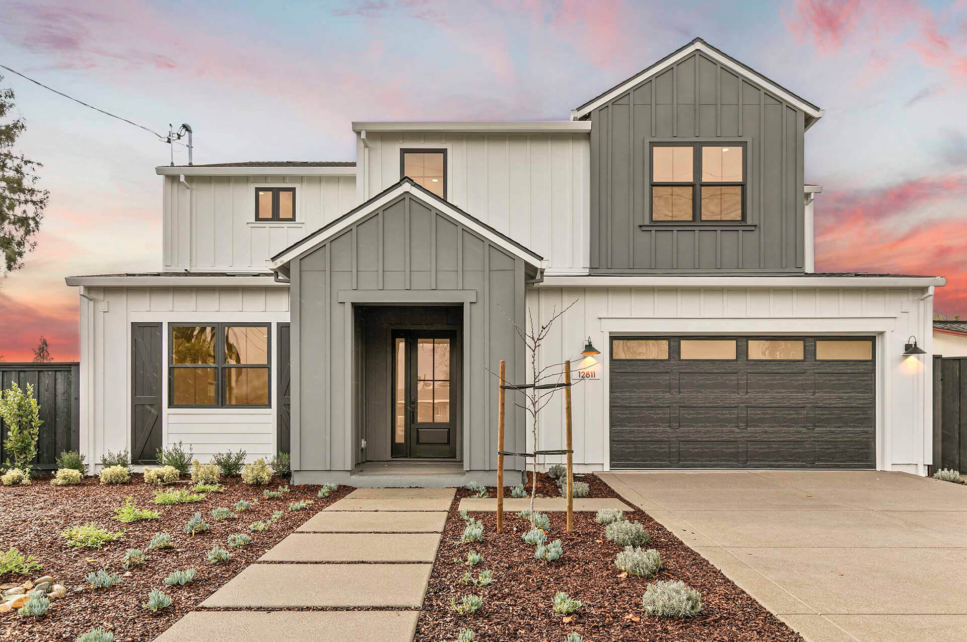 TJH Verbena — gray and white siding, black-framed windows, double garage, and front landscaping