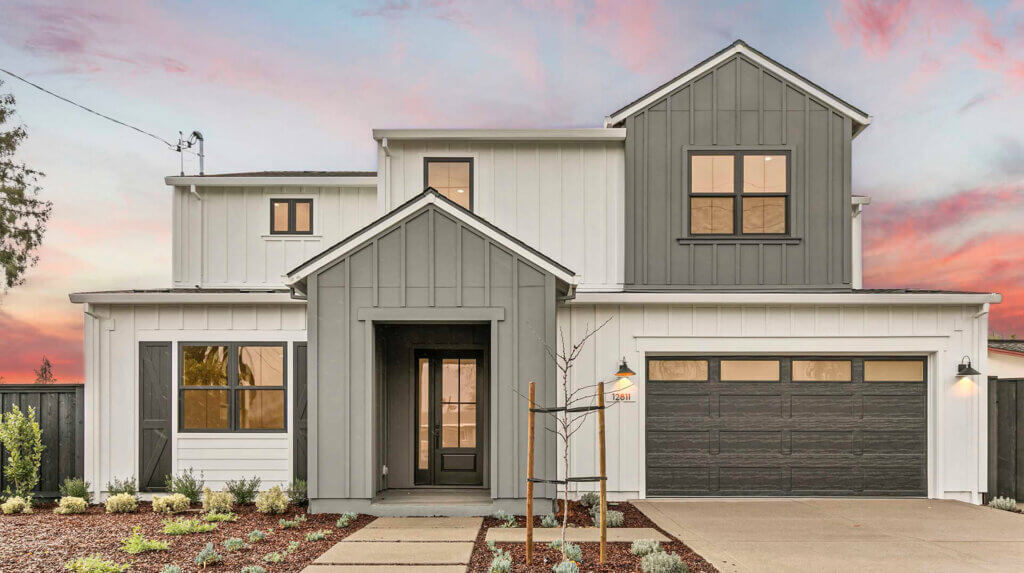 TJH Verbena — gray and white siding, black-framed windows, double garage, and front landscaping